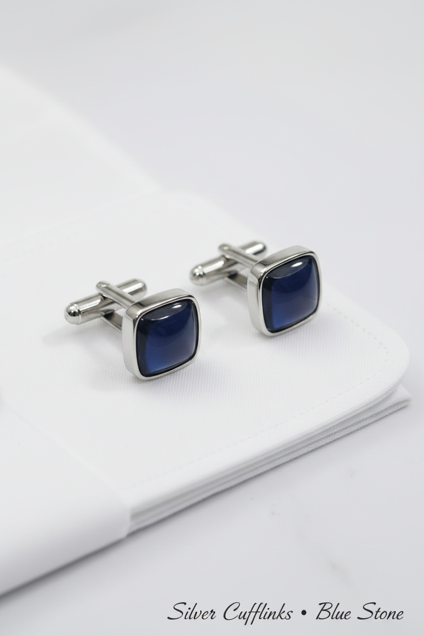 Close-up of silver cufflinks with blue stone