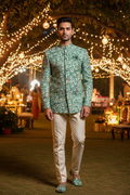 Front view party background - Bandhgala in teal daisy print fabric with cream trousers and matching jooti