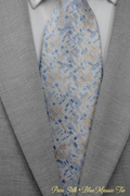 Close-up of light blue mosaic silk tie with script